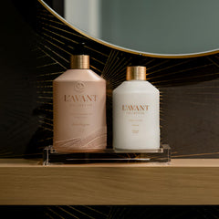 L'AVANT Collective bottle closeup in pink glass showcases premium design.