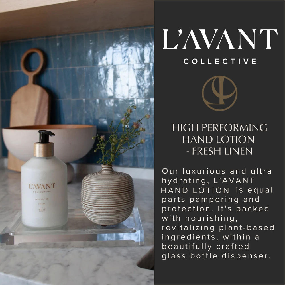 Elegant glass bottle of L'AVANT Collective Hand Lotion on a vanity.