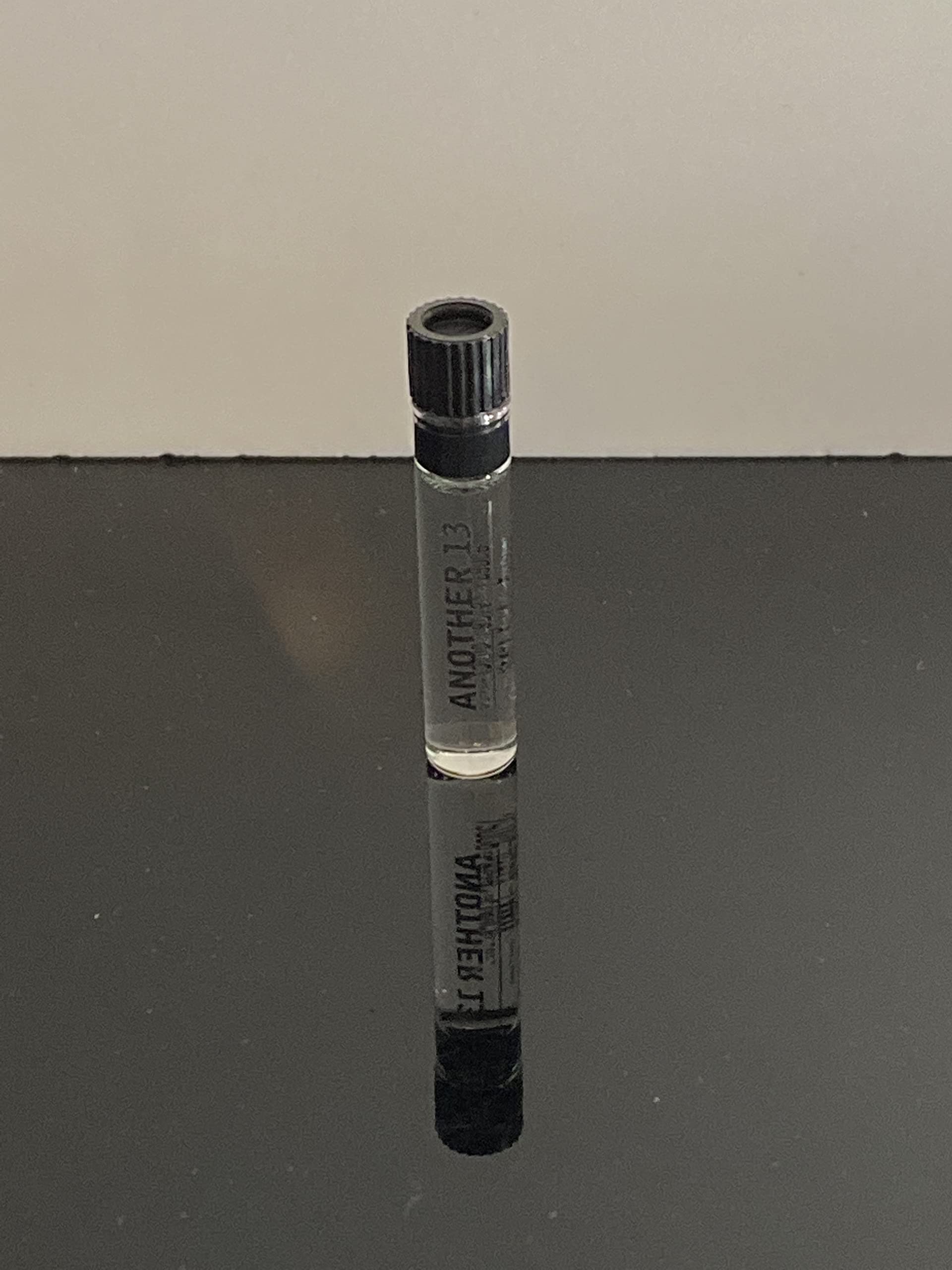 A swatch next to the bottle to explore the fragrance's airy, woody-musk vibe.