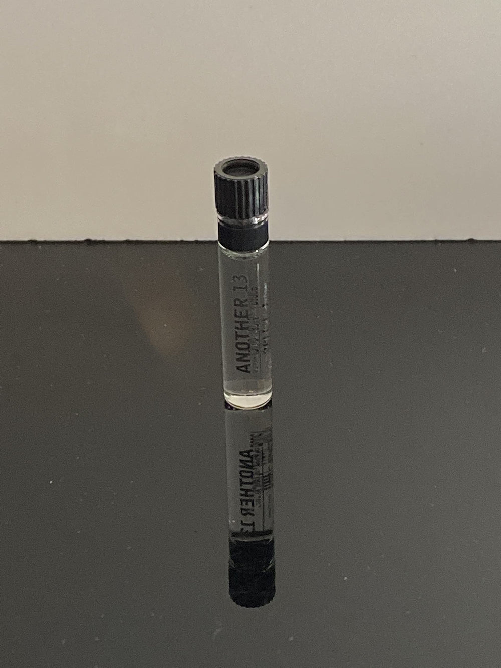 A swatch next to the bottle to explore the fragrance's airy, woody-musk vibe.