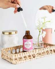 Dropper dispensing Leven Rose Emu Oil for targeted skincare use.