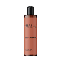 Life & Pursuits Amla Brahmi Oil bottle pouring for scalp nourishment