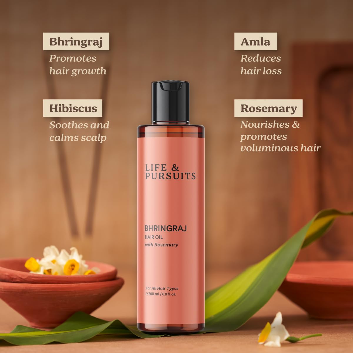 Life and Pursuits Ayurvedic ingredients display including rosemary, amla, hibiscus for hair care.