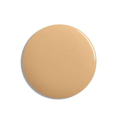 Lisa Eldridge seamless skin tint application dots across cheeks and forehead for even, buildable coverage.