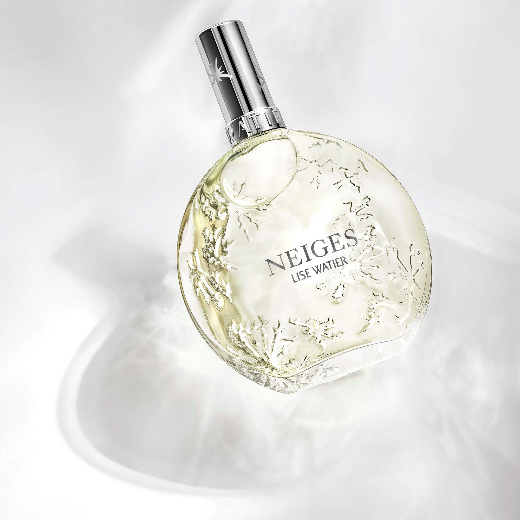 Lise Watier Neiges bottle cap close-up, hinting at premium fragrance experience