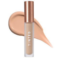 Live Tinted Hueskin Serum Concealer applied under the eye for brightness.