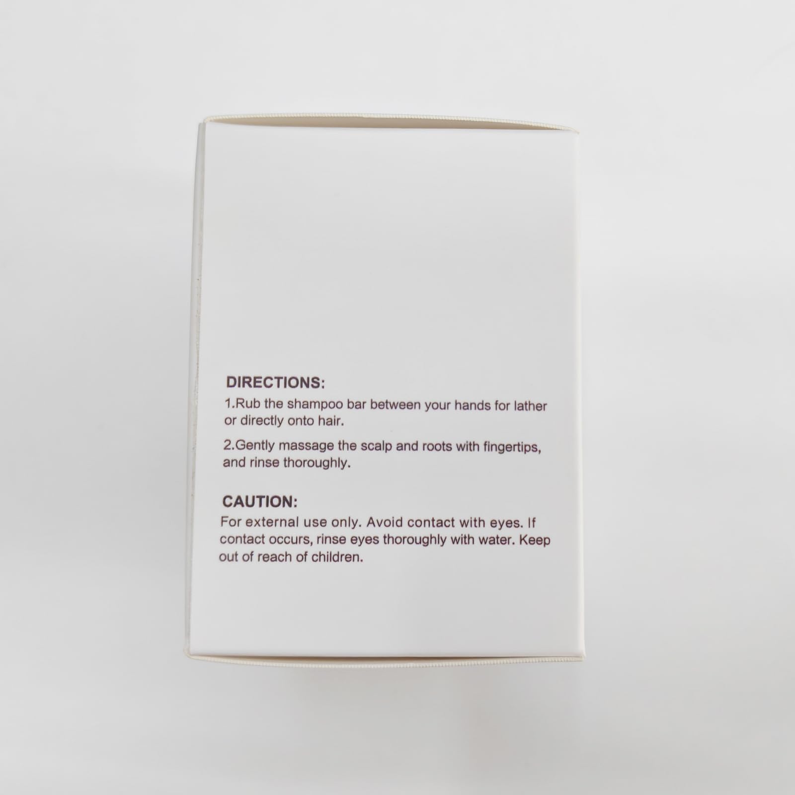 LIYALAN shampoo bar held in hand, ready for direct application.