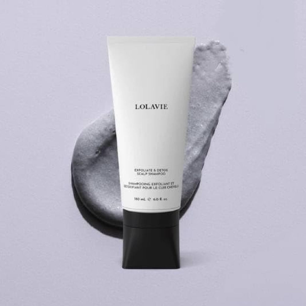 LolaVie Exfoliate & Detox scalp scrub in hand highlights charcoal exfoliation benefits.