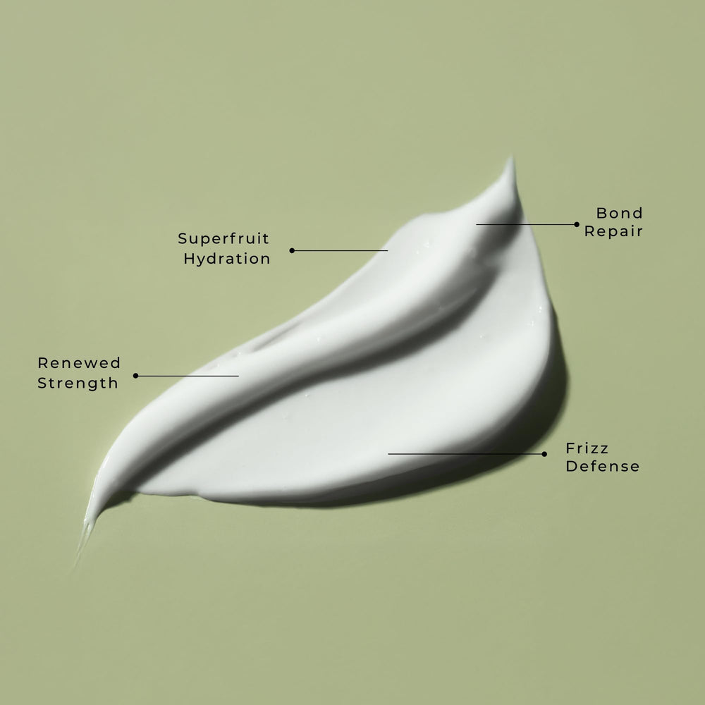 LolaVie Restorative Conditioner bottle-cap closeup highlights easy dispensing and lightweight feel
