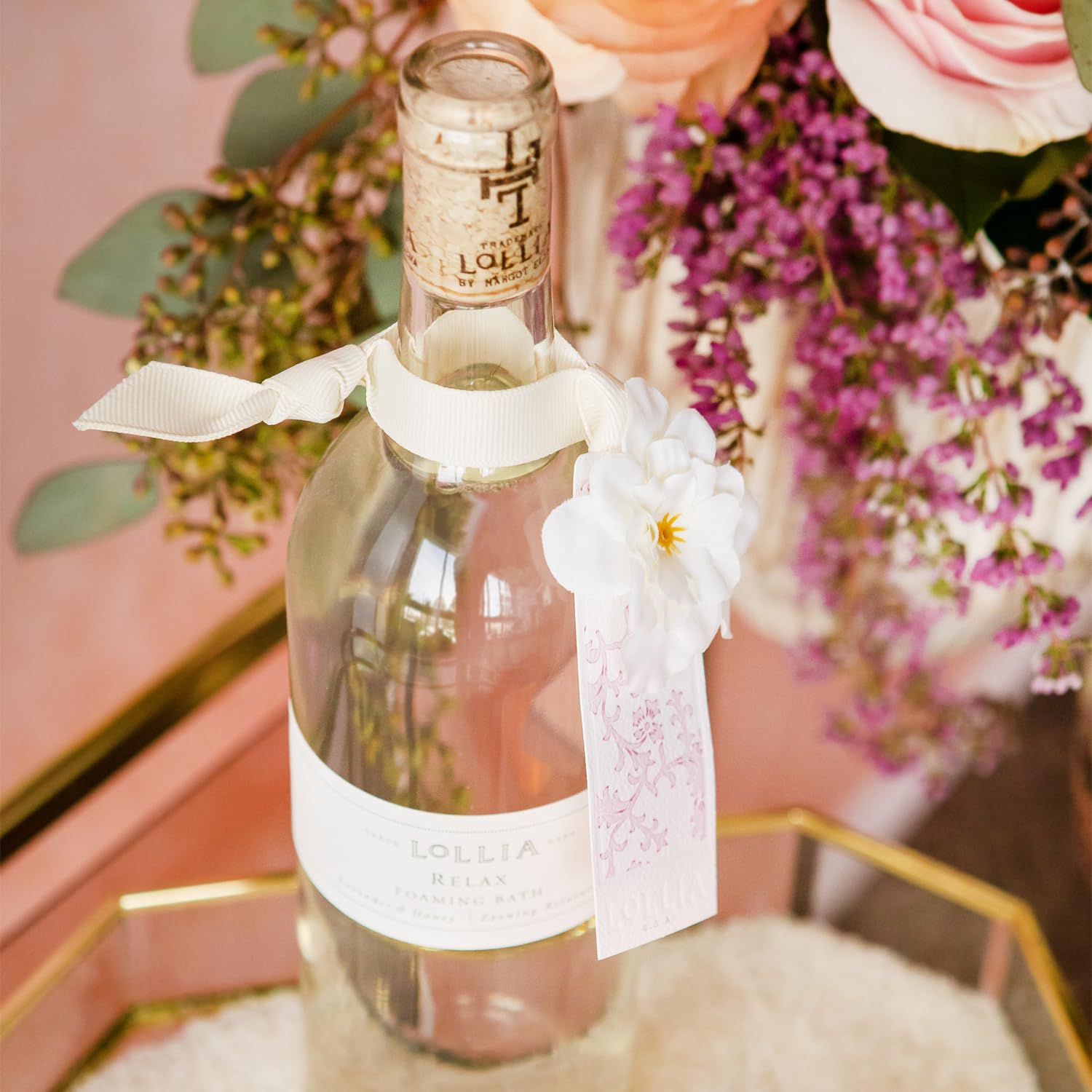 Lollia Relax being poured into a warm bath for a luxurious self-care ritual