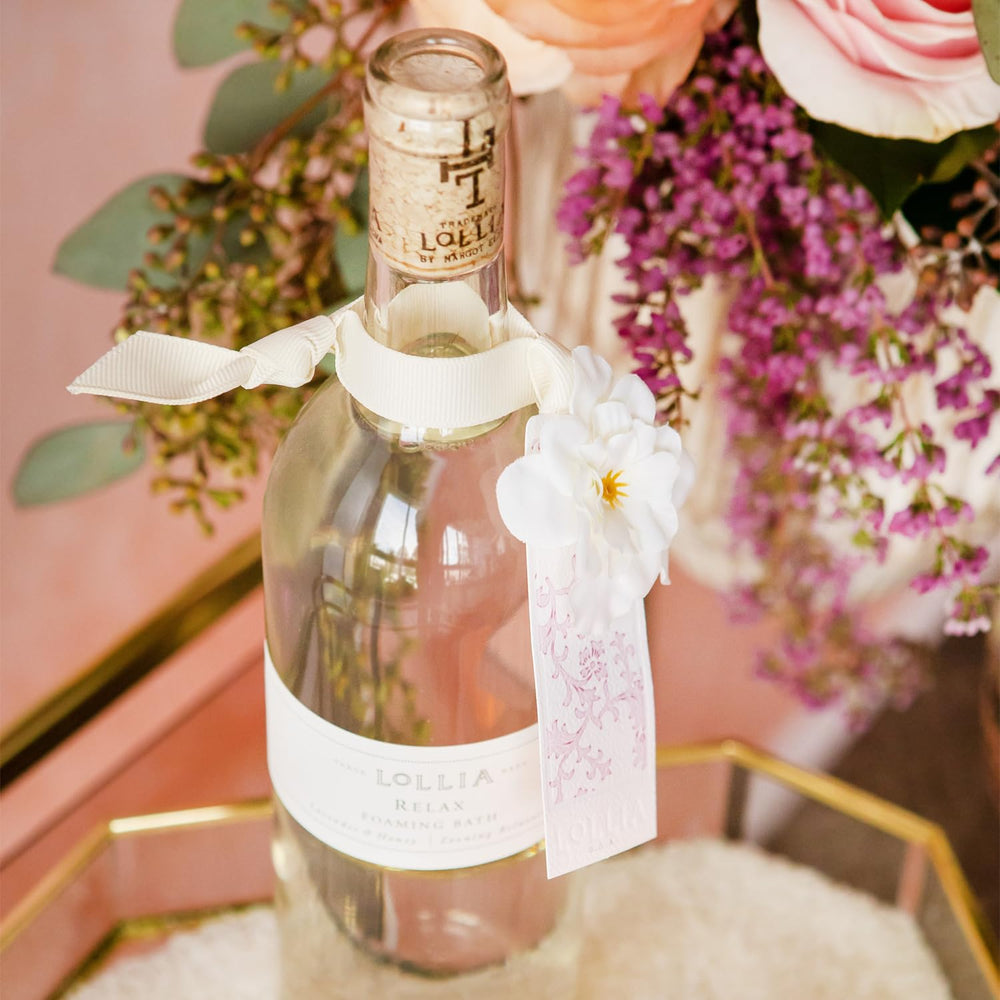 Lollia Relax being poured into a warm bath for a luxurious self-care ritual