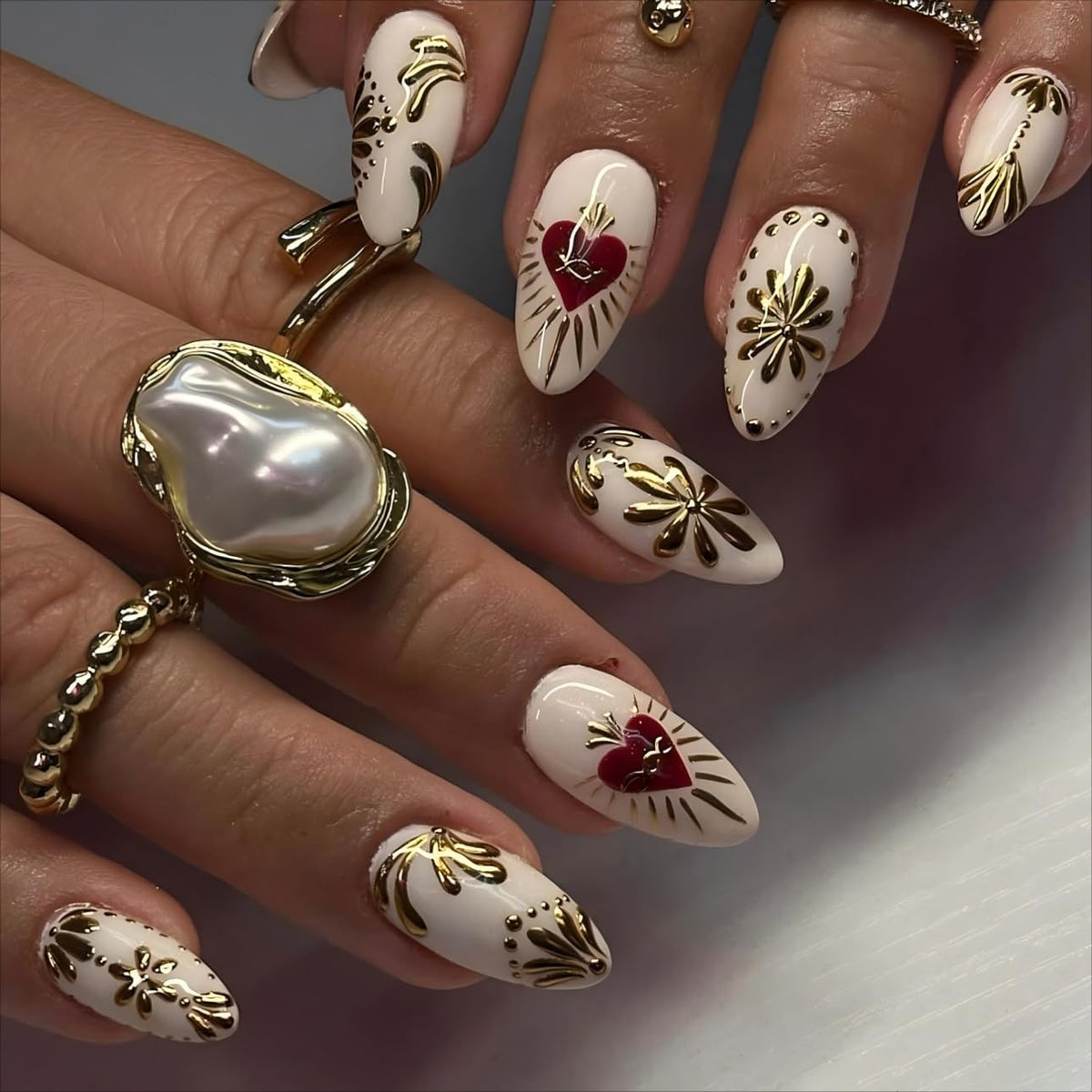 LPOODDNU almond 3D gilding nails with gold accents for salon-style elegance at home.