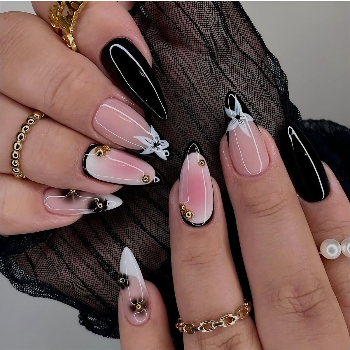 LPOODDNU black-white almond press-on nails with flower and gold beads for chic French style.