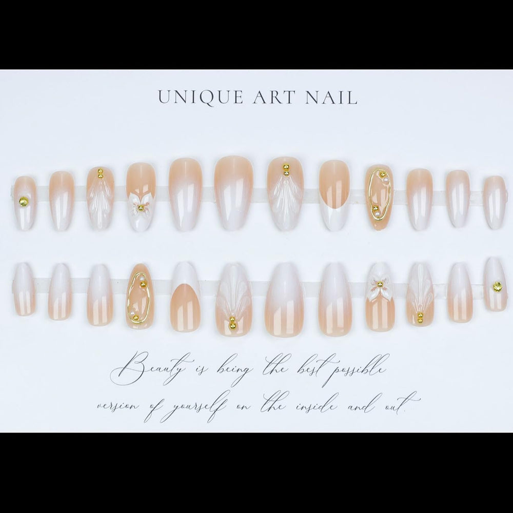 LPOODDNU almond press-on nails with white tips and gilded details.
