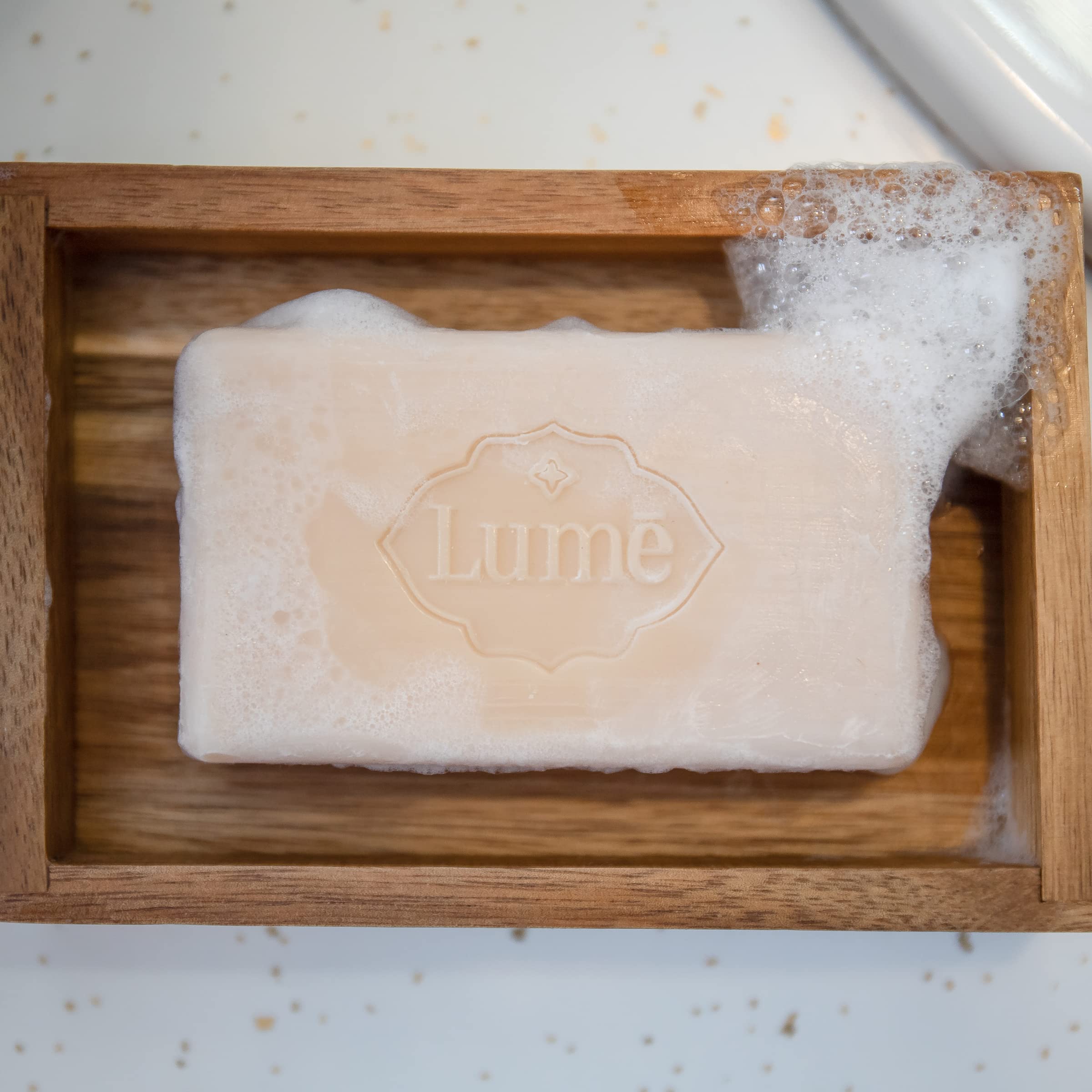 Lume bar soap doubles as a shampoo bar for versatile use.