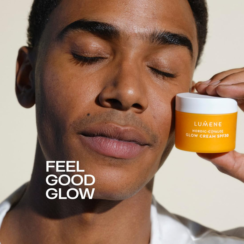 Lumene Nordic-C Valo Glow Moisturizer beside glass of water emphasizing hydration.