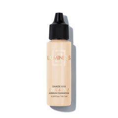 LUMINESS Air Silk 4-in-1 bottle pour showing smooth, controlled application for satin finish.