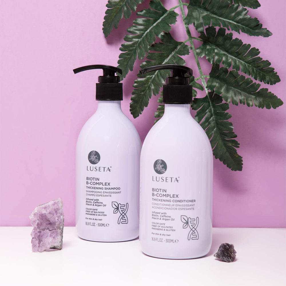 Luseta Biotin B-Complex Conditioner bottle held to show for strengthened, smoother hair