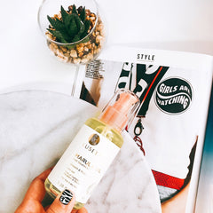 Luseta Marula Oil Hair Treatment serum texture on hair strand showing hydration and softness.