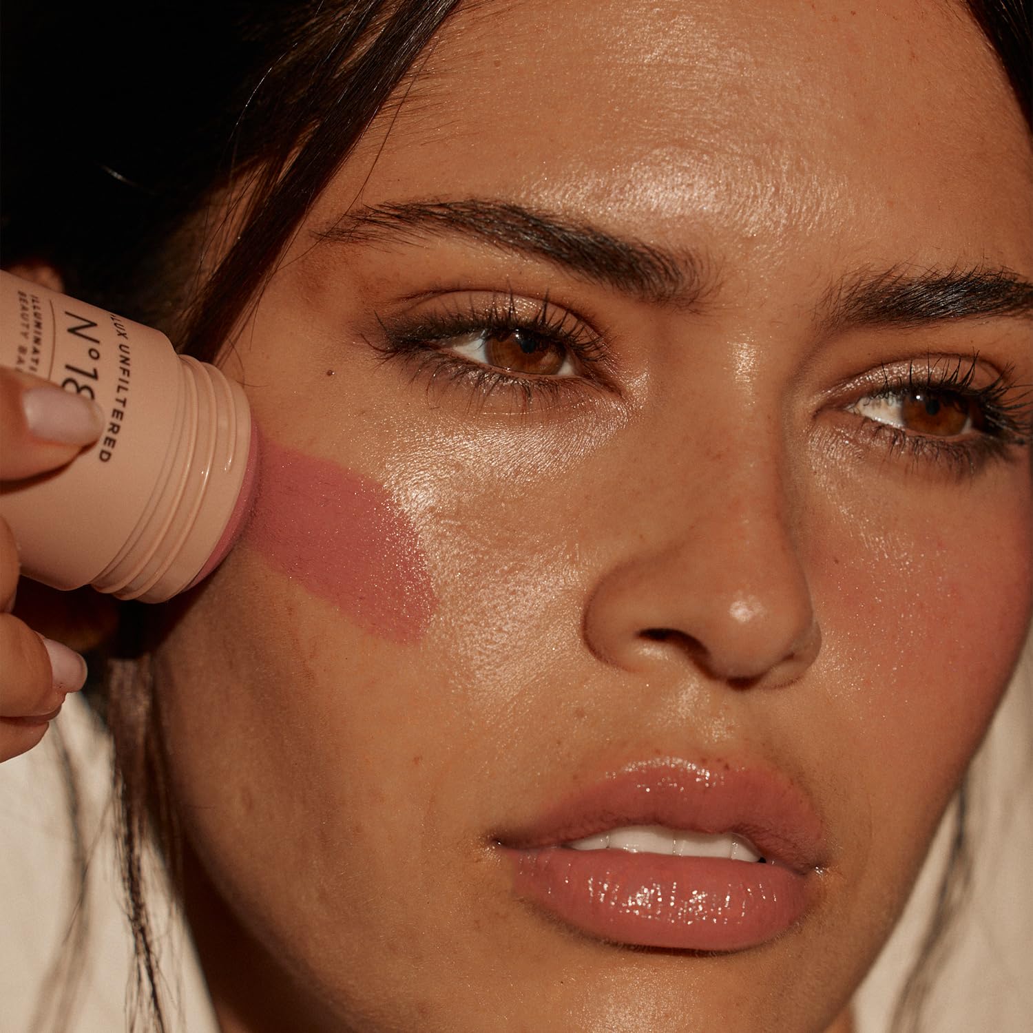 Lux Unfiltered N°18 texture close-up shows mango butter effect on skin.