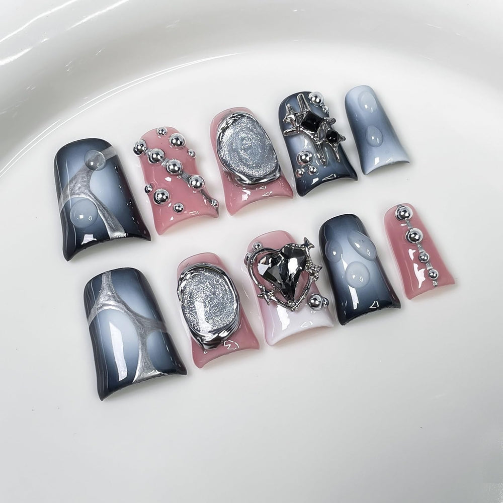 Handmade press on nails with 3D embossing in steel ball and heart accents.