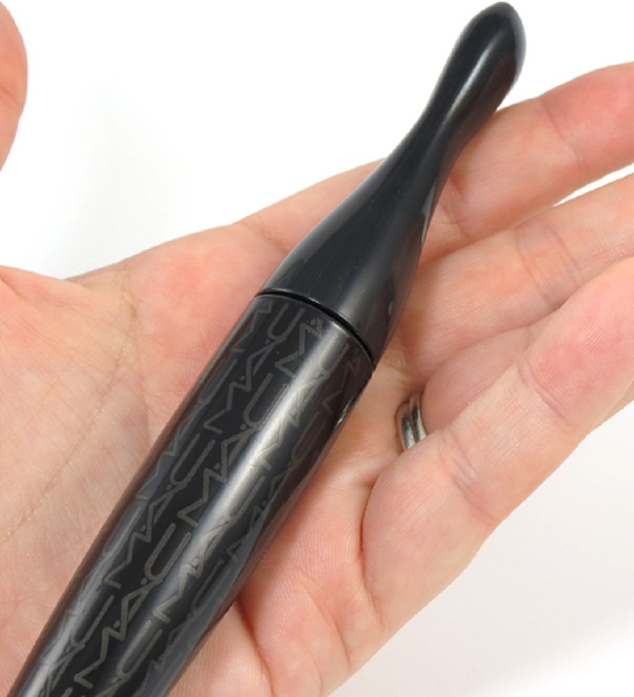 MAC mascara swatch on skin shows deep black color and smooth finish.