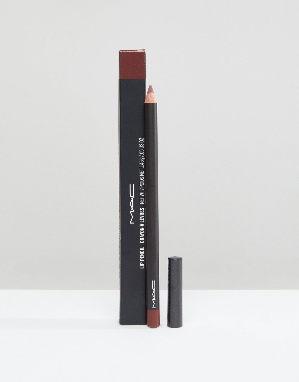 MAC Lip Pencil Mahogany swatch on arm shows rich, even color.