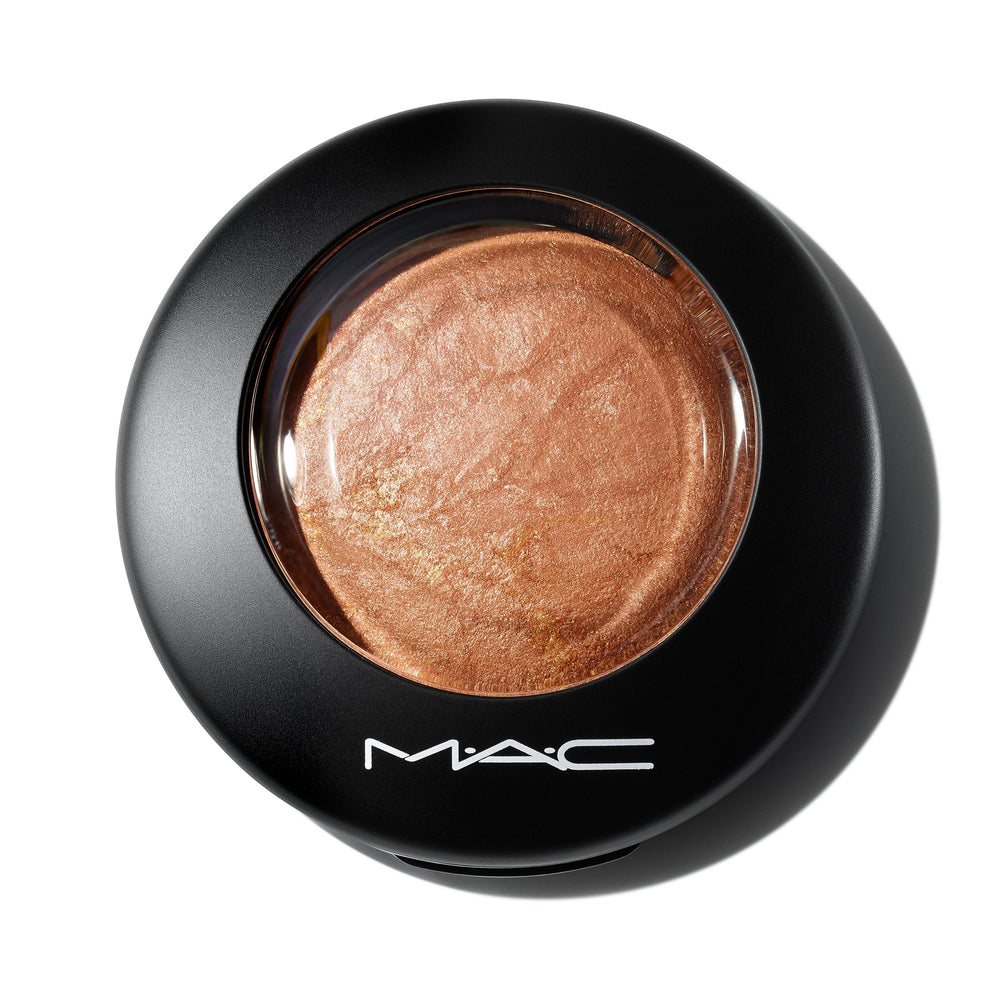MAC Mineralize Skinfinish Global Glow swatch on the cheek shows subtle toasted glow