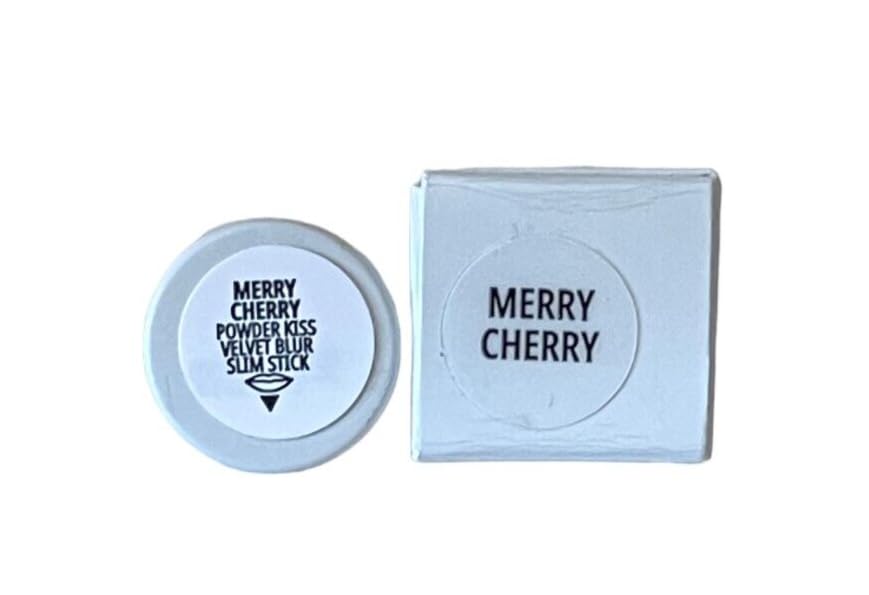 MAC Powder Kiss Velvet Blur Slim Lipstick Merry Cherry swatch captures rich cool-toned red.