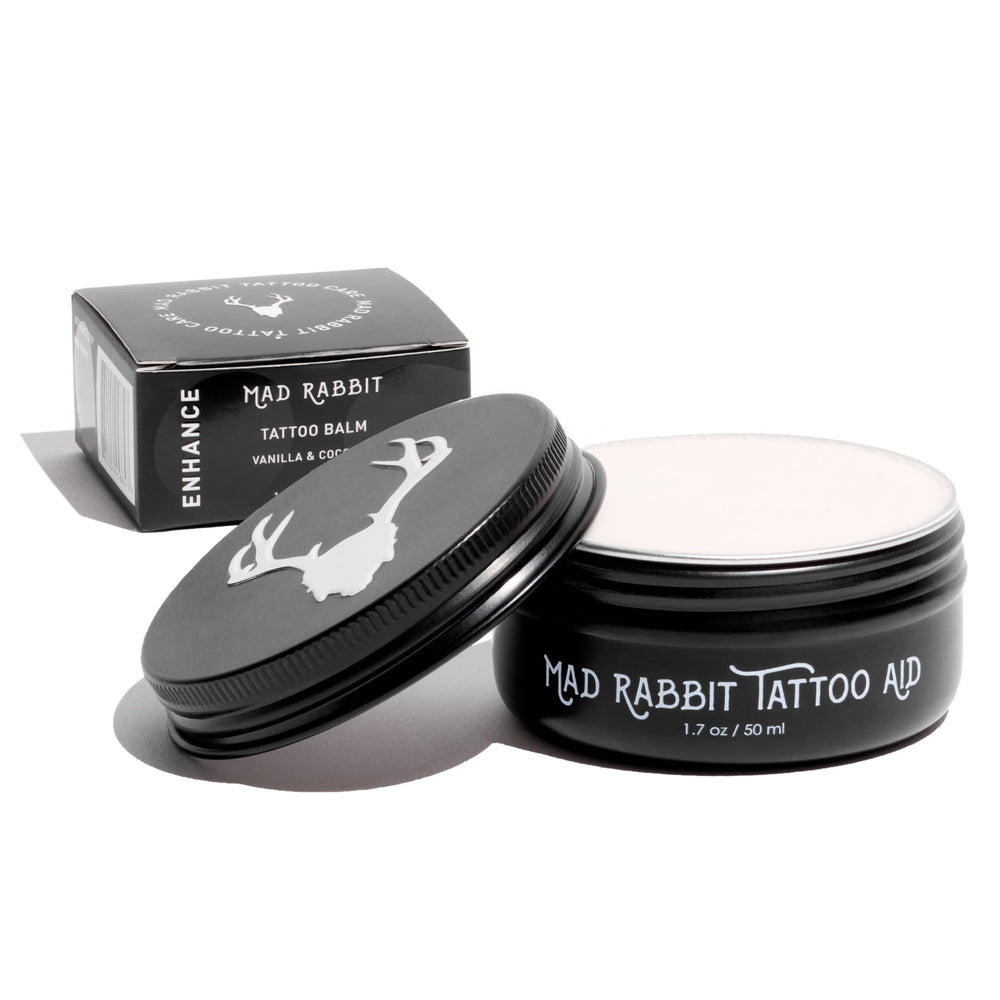 Mad Rabbit Tattoo Balm bottle for color enhancement, ready to apply.