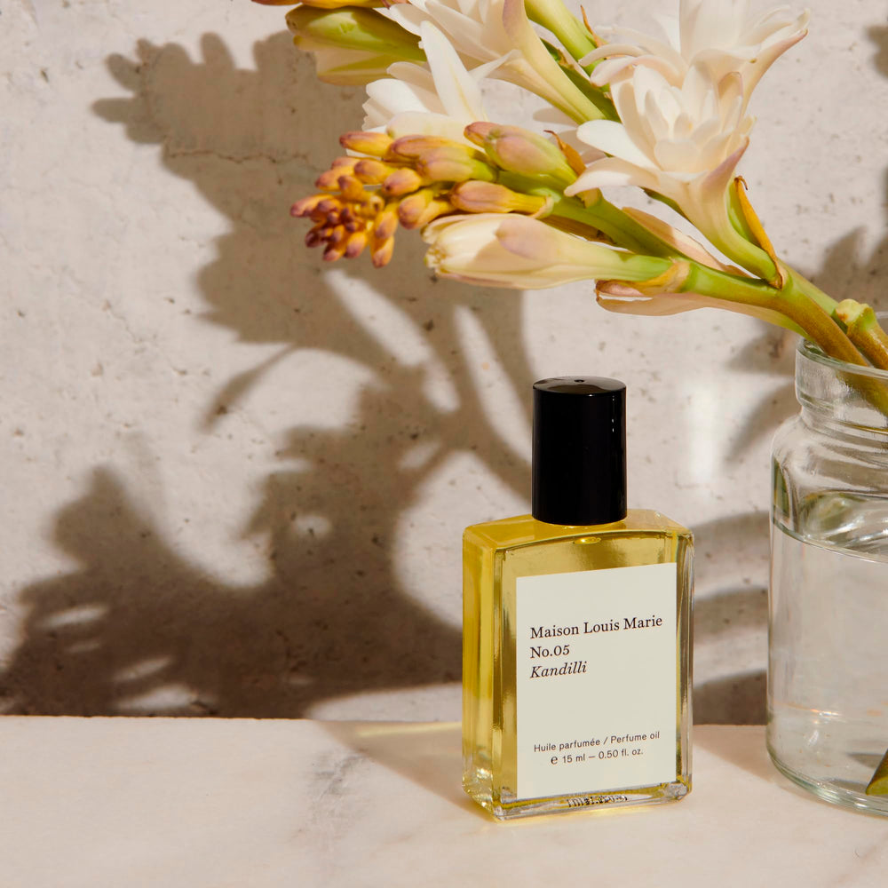 Kandilli roll-on applied to pulse points for intimate scent along the neck and wrists.