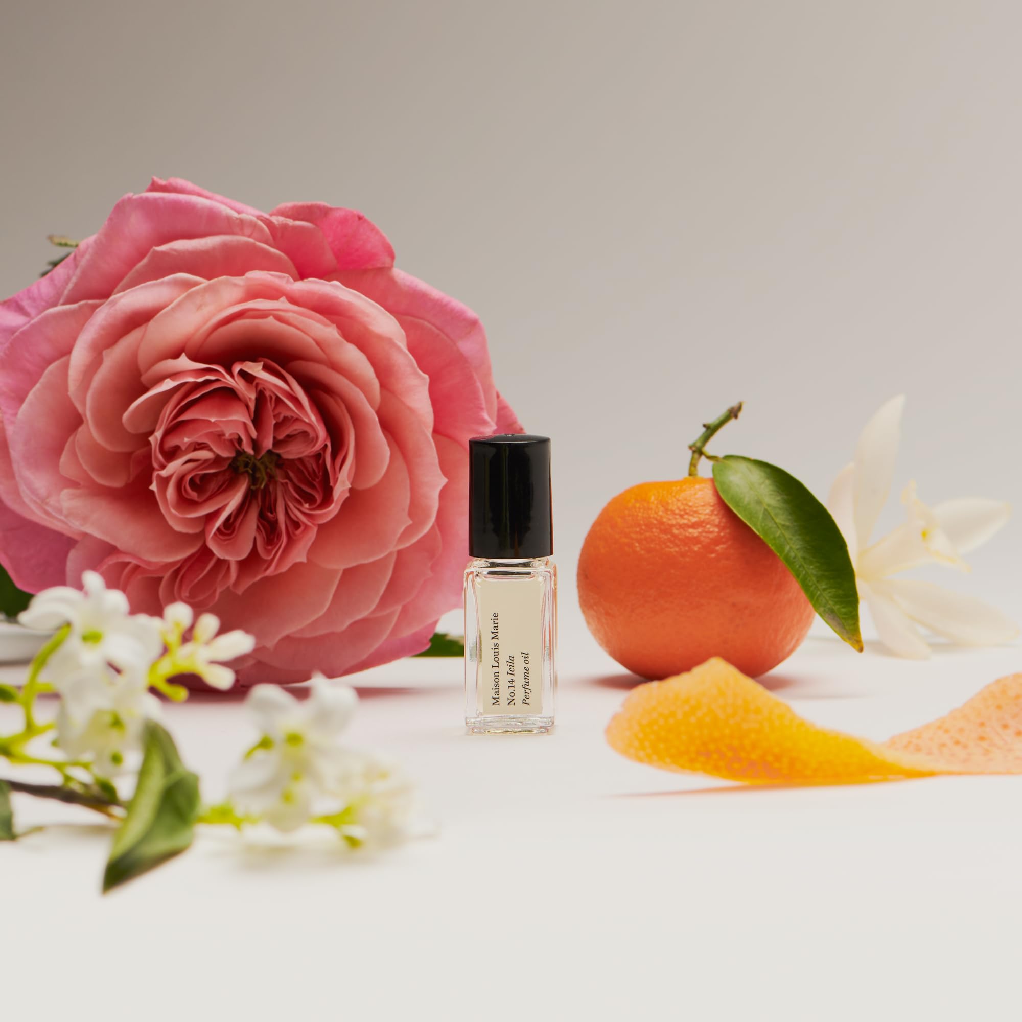 Icila fragrance notes collage highlights citrus, florals, and woods