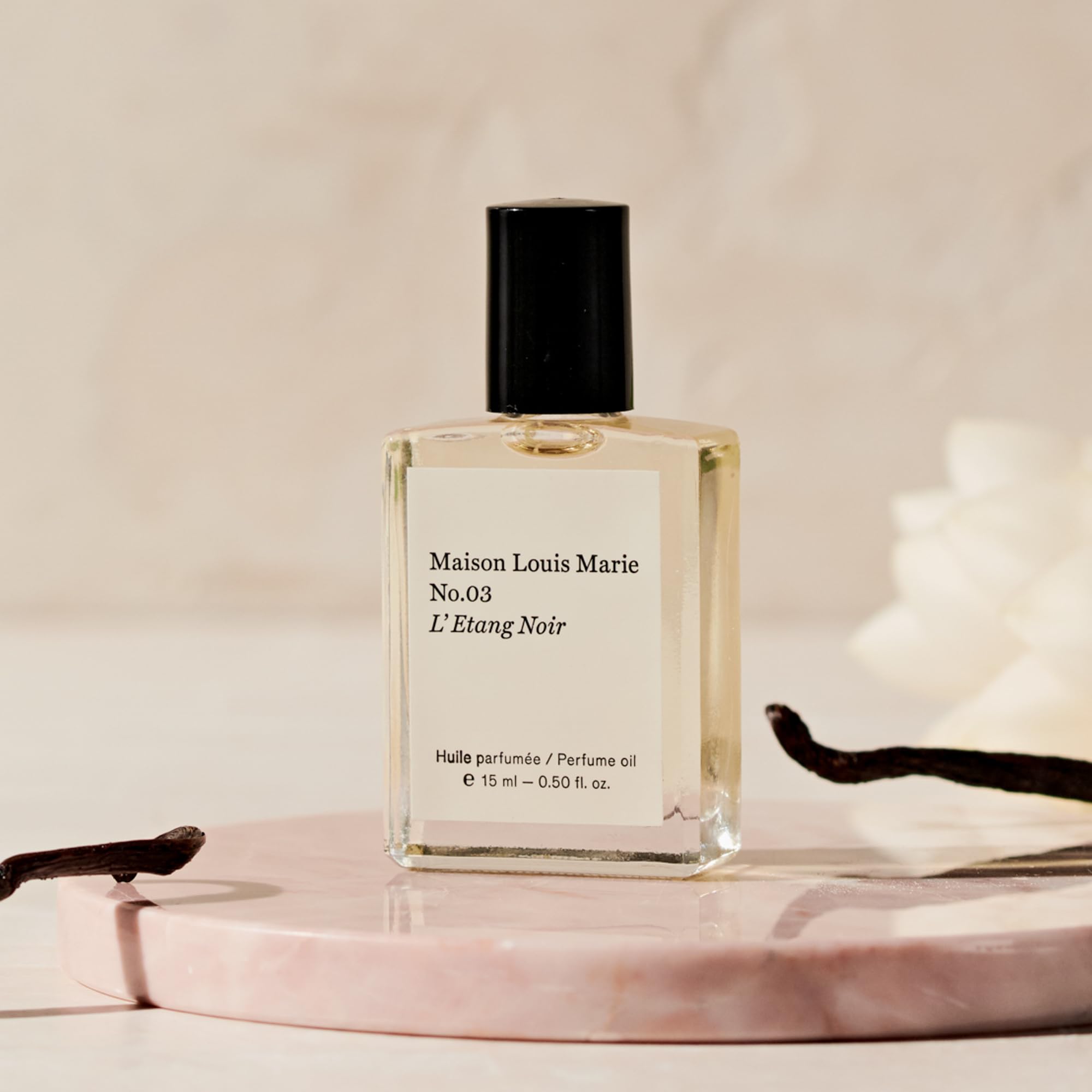 Applying Maison Louis Marie No.3 Étang Noir on pulse points.