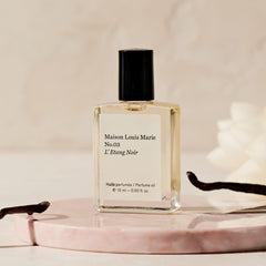 Applying Maison Louis Marie No.3 Étang Noir on pulse points.