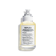 Maison Margiela Replica Afternoon Delight bottle closeup showing warm vanilla notes for cozy evenings.