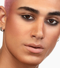 Amber Glow nude coral shade adds natural warmth to cheeks.