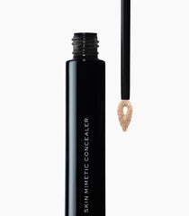 Under-eye application of MAKE Skin Mimetic Concealer for brightening.