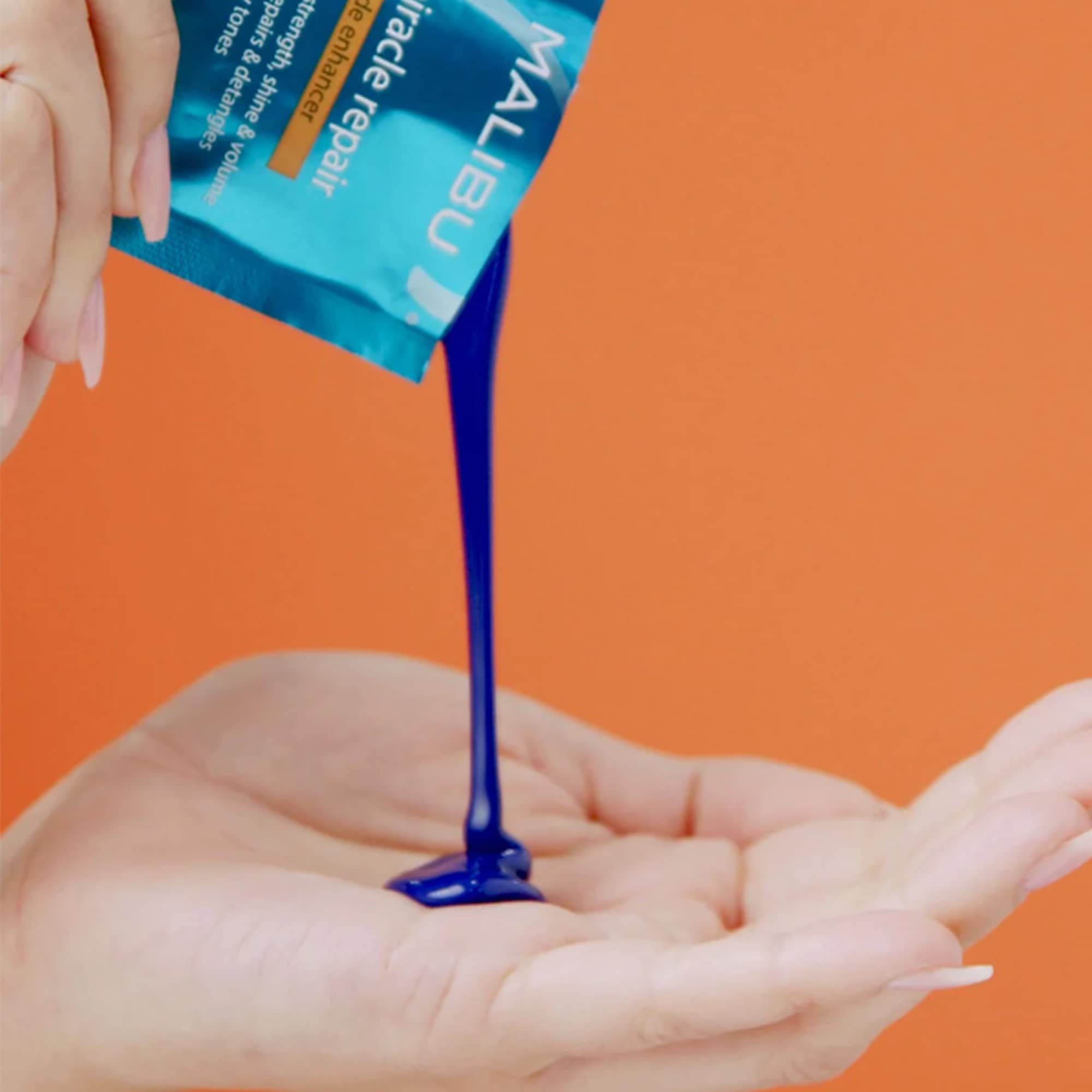 Malibu C Miracle Repair Blonde Enhancer packet in product shot, counters brassiness with purple toning.