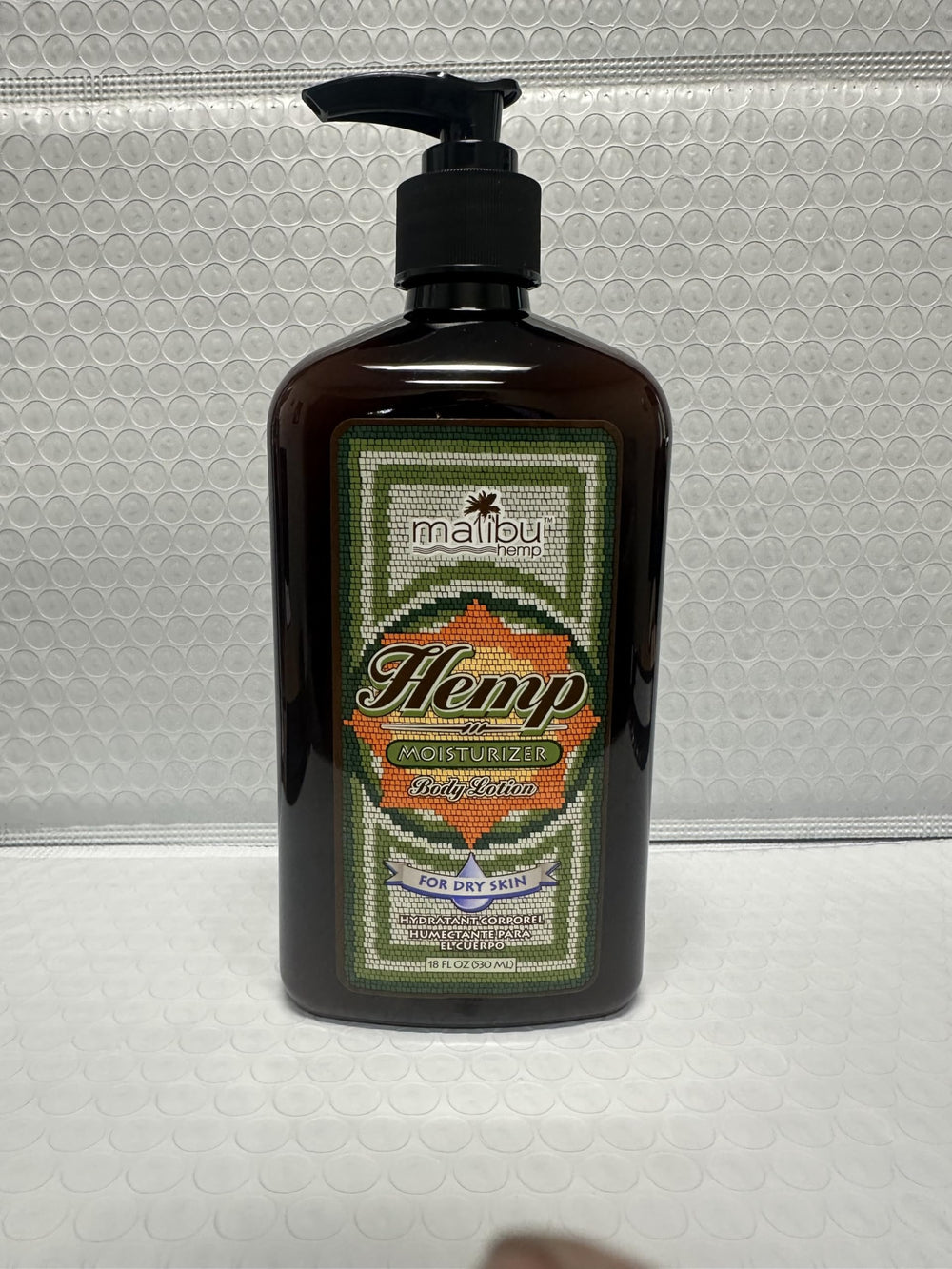 Shelf display of Malibu Tan packaging conveys value and presence.