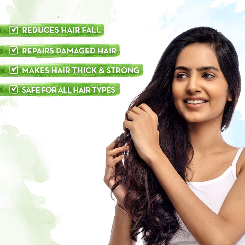 Mamaearth Onion Oil Hair Mask applying a rich layer for smoother, softer strands.