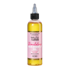 The Mane Attraction hair oil bottle pours for easy application and growth support.