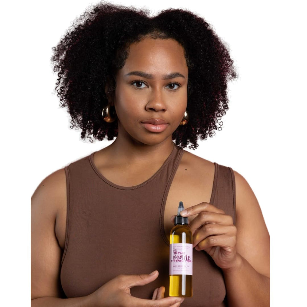 The Mane Attraction bottle on hair reveals a silky shine and moisture lock.