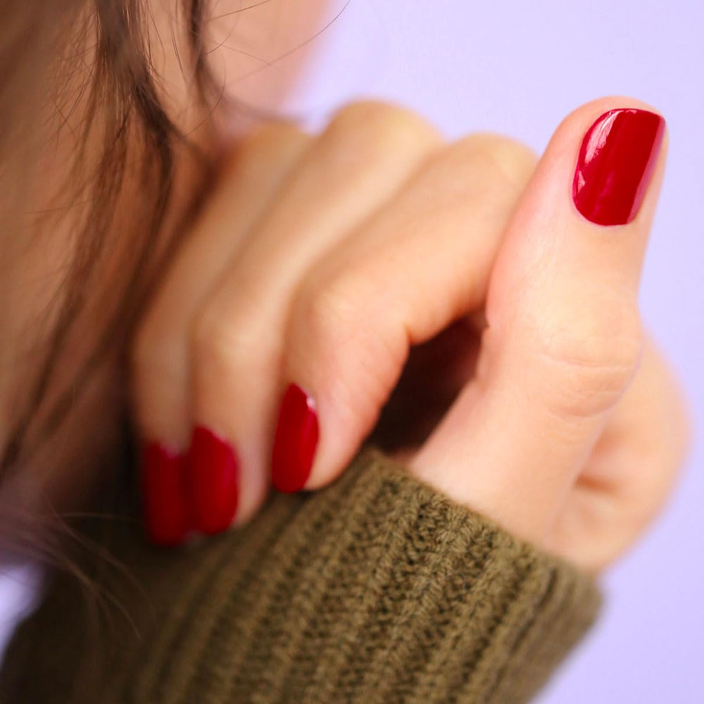 Manucurist Red Cherry nail swatch shows opaque color.