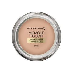 Max Factor Miracle Touch foundation bottle close-up in Warm Almond for even complexion.