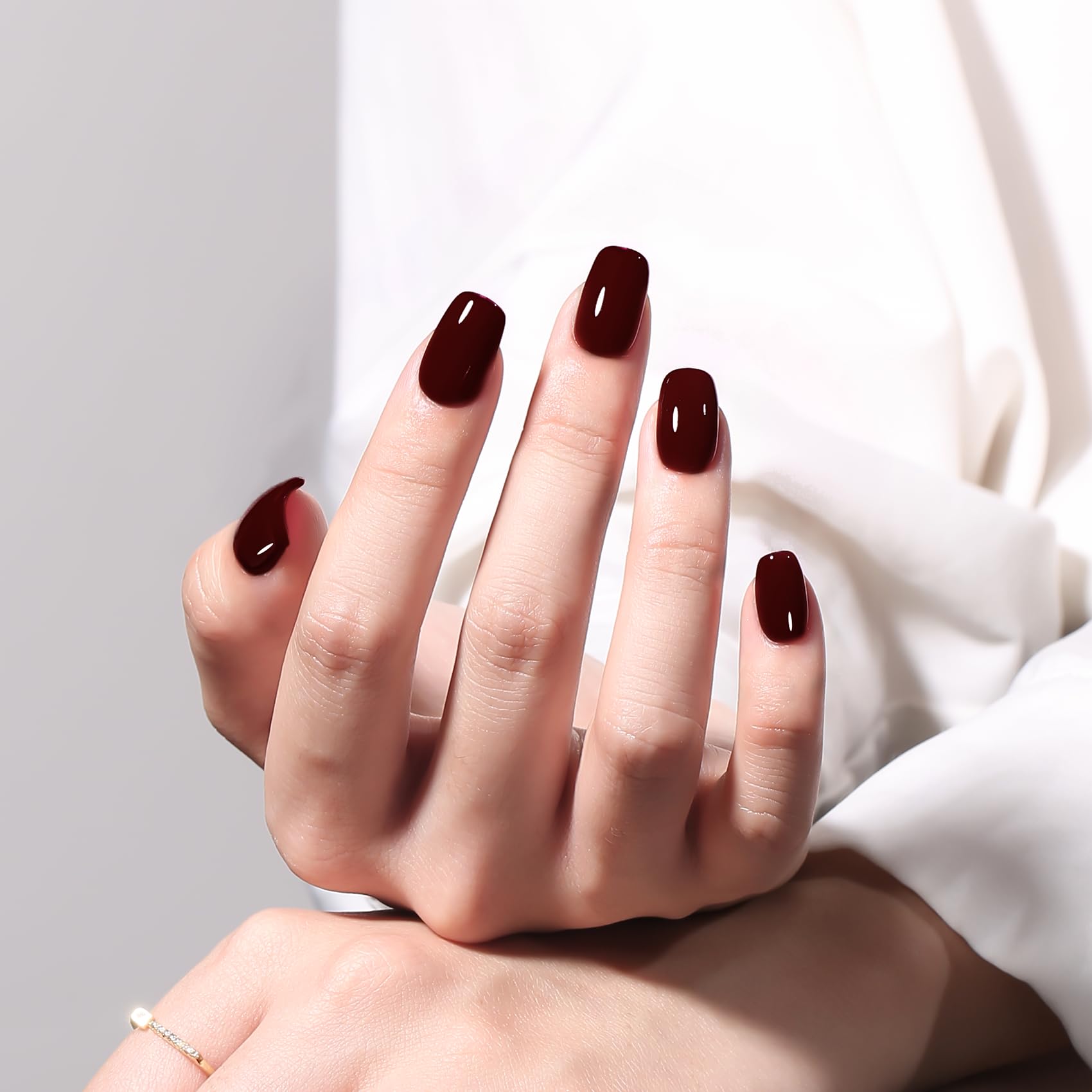 MAYCHAO Deep Cherry Red gel polish on nail for a salon-like finish.