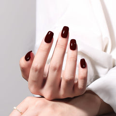 MAYCHAO Deep Cherry Red gel polish on nail for a salon-like finish.