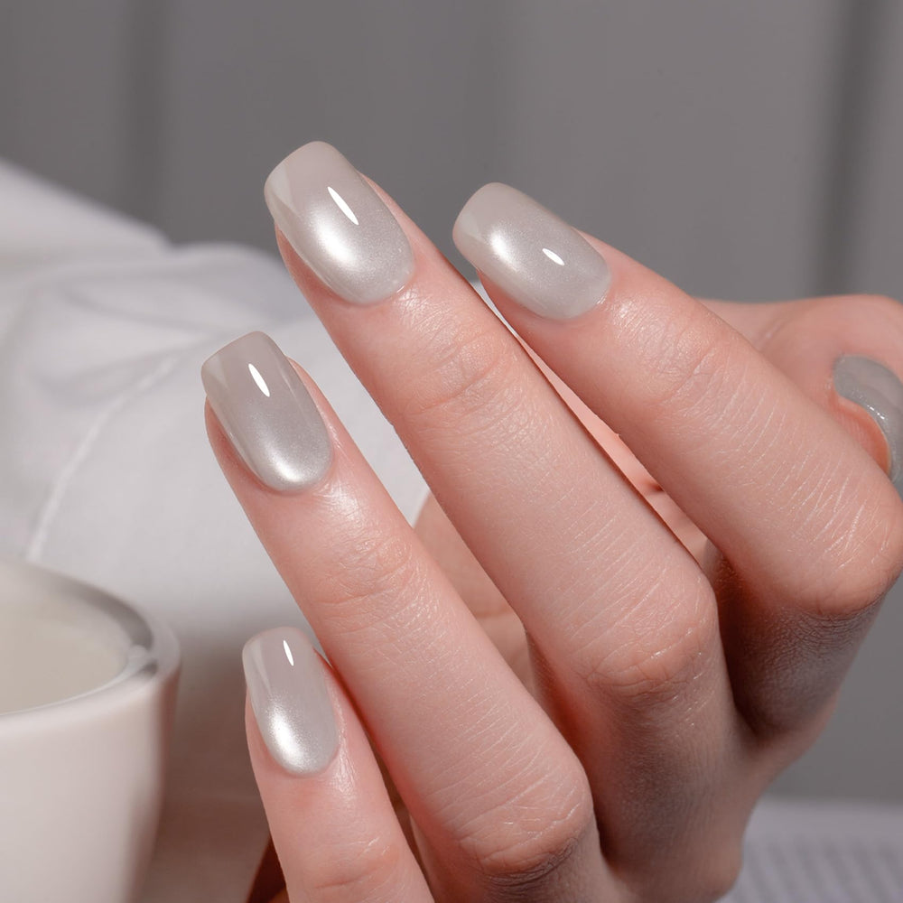 MAYCHAO Silk Silver Cat Eye gel polish undergoing LED cure for quick setting.