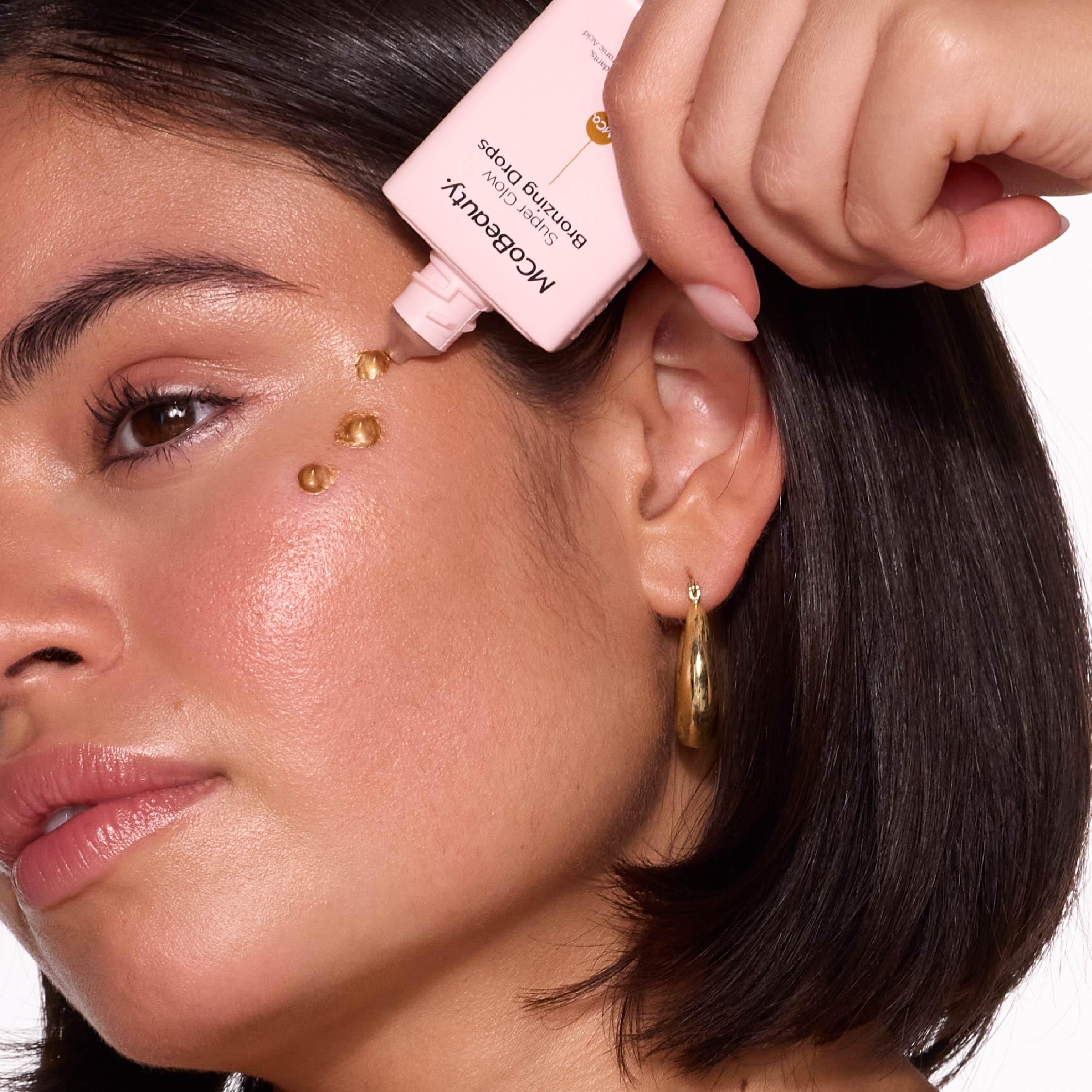 Swatches of MCoBeauty Bronzing Drops demonstrating warm bronze payoff