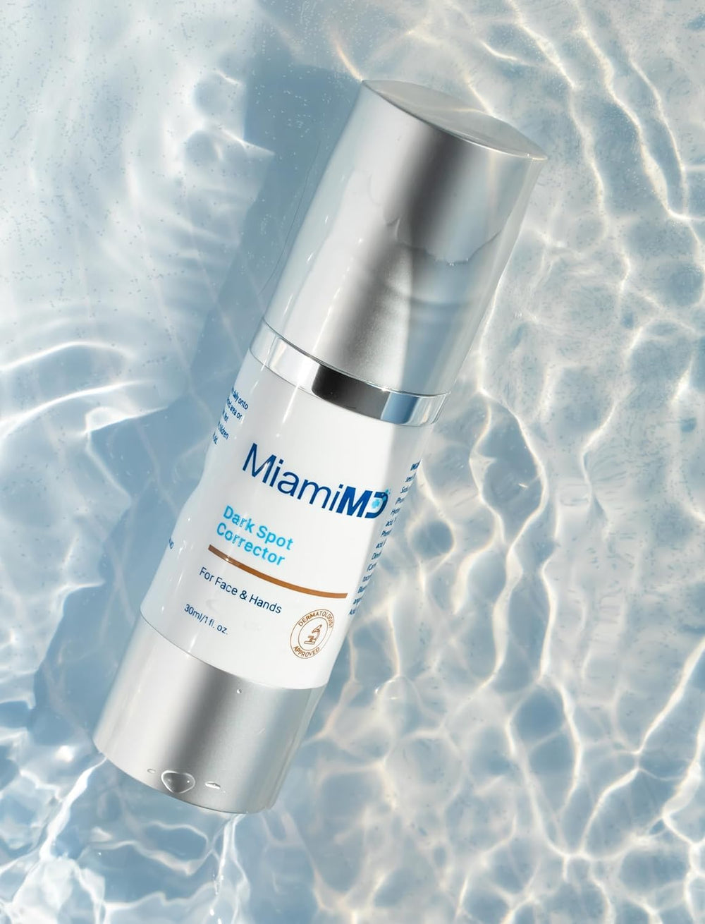 Hand applying MiamiMD Dark Glow Renewal Serum for multi-area coverage.