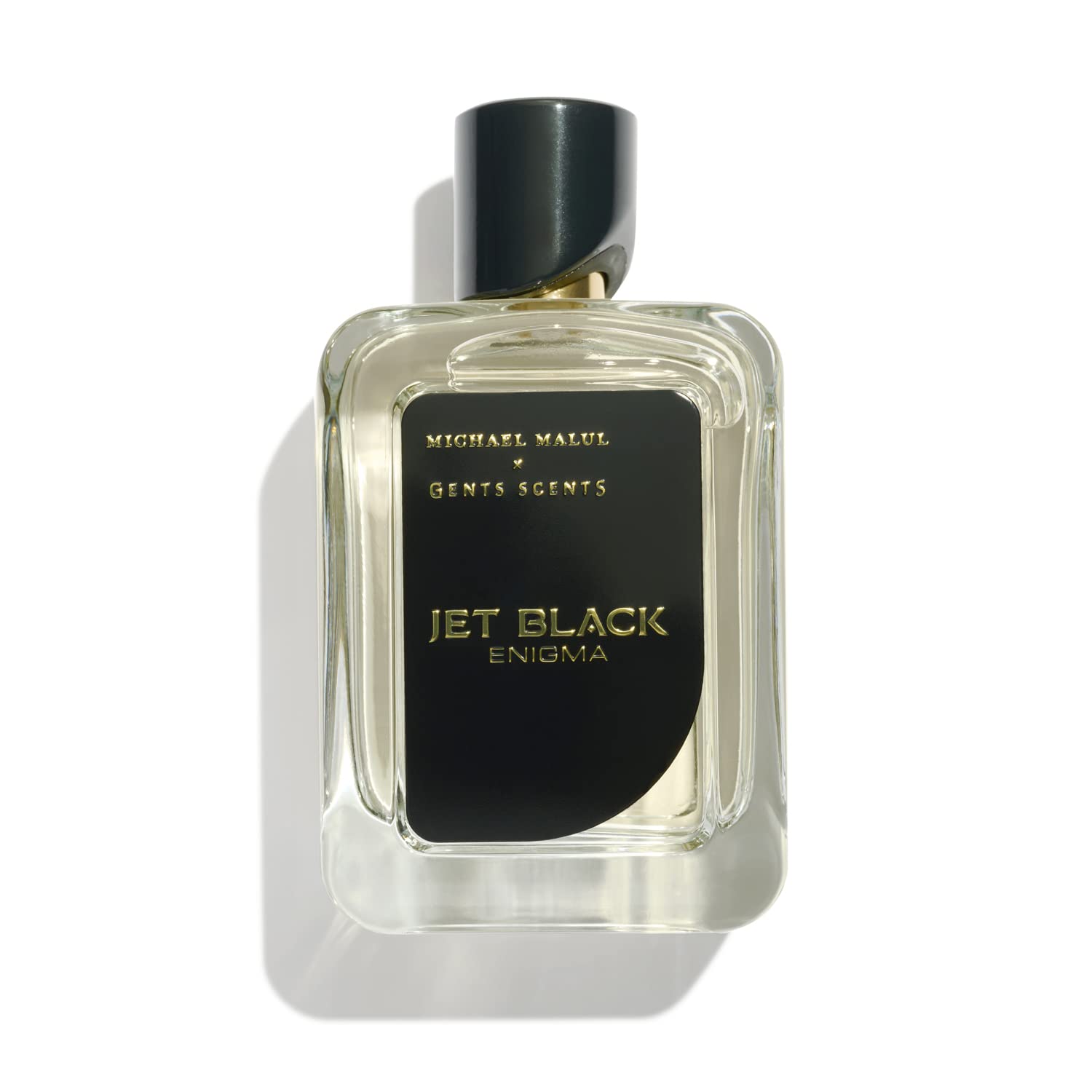 Michael Malul Jet Black Enigma bottle on a dark bar counter, commanding attention.